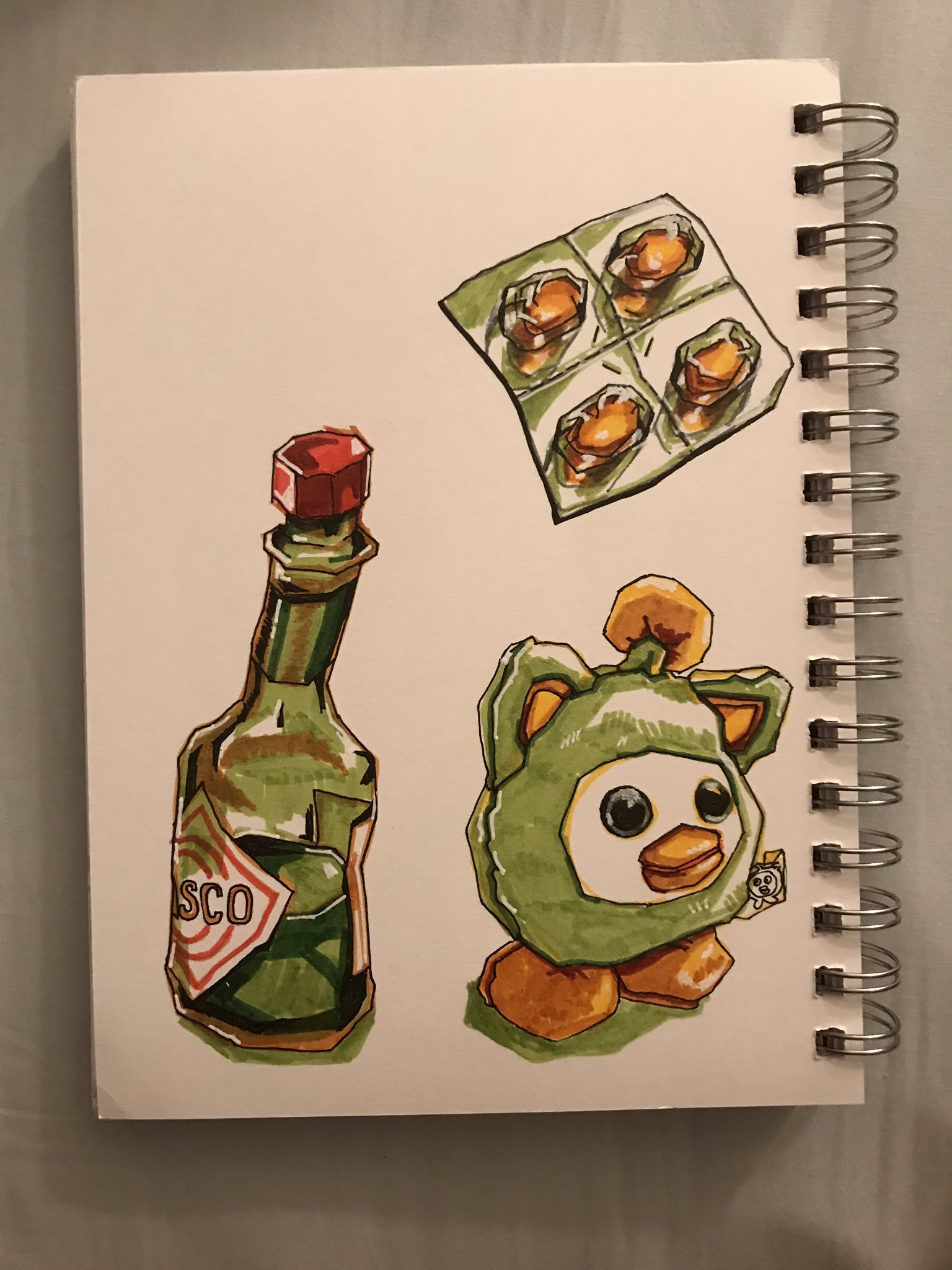 Photo of a sketchbook page with drawings of Tabasco, Advil tablets, and a Oui Oui stuffed animal