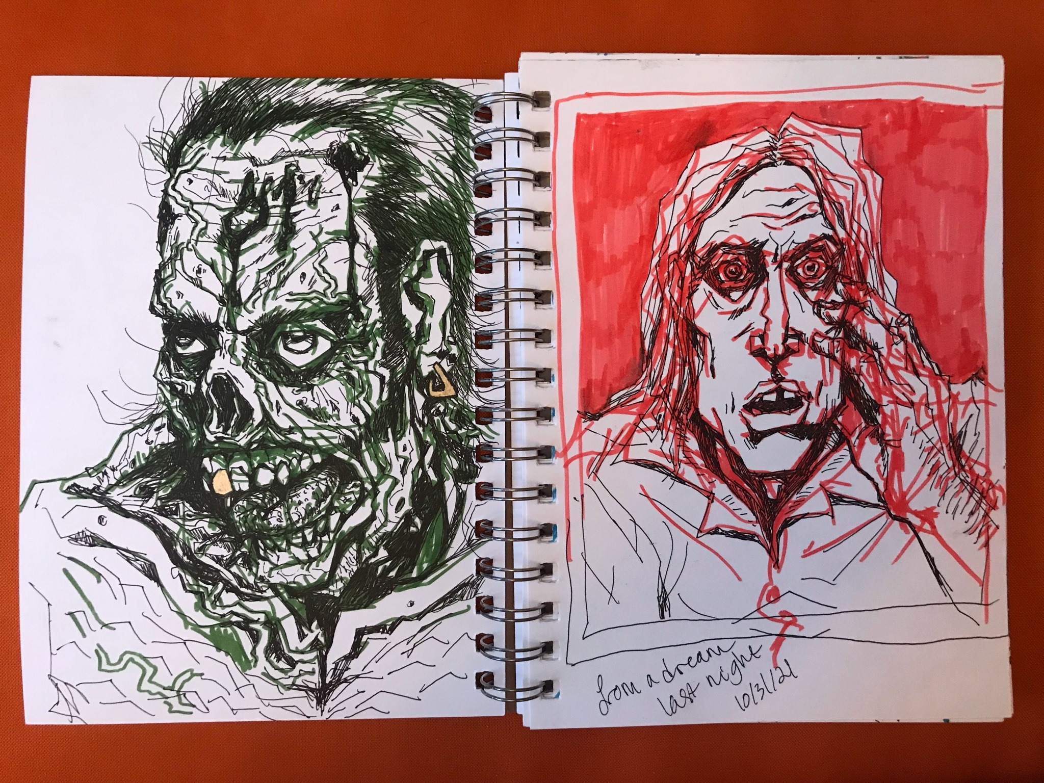 Photo of two sketchbook pages: both are marker dawings. One is a zombie with the name 'Amy' carved into his forehead, the other is Astral my OC looking into a mirror with wide eyes.