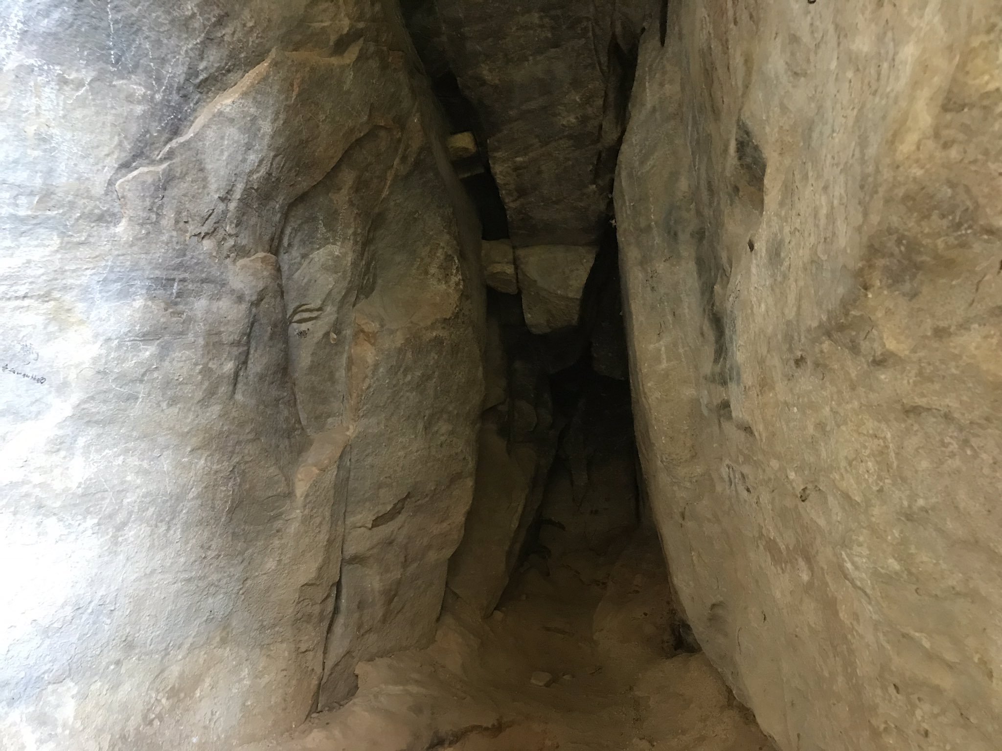 Photo of a cave entrance going into darkness