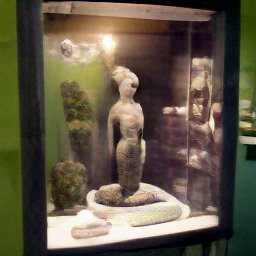 AI generated image of a stone statue of a mermaid in a altars exhibit behind glass