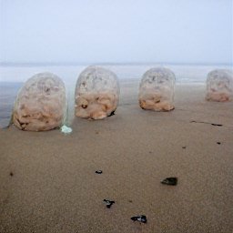 AI generated image of lumps of flesh in a line on a misty beach