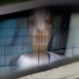 AI generated image of what looks like a cinderblock wall but blurry, with an even blurrier image of a human face and shoulders seemingly painted onto it