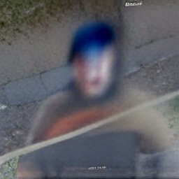 AI generated image of a blurry photo of sidewalk and road with an even more out of focus figure superimposed. The figure is vague and grayish, but has blue hair or a blue hat on