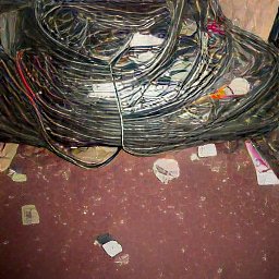 AI generated image of a flash photo of a bunch of dirt and wires tangled on a red carpet