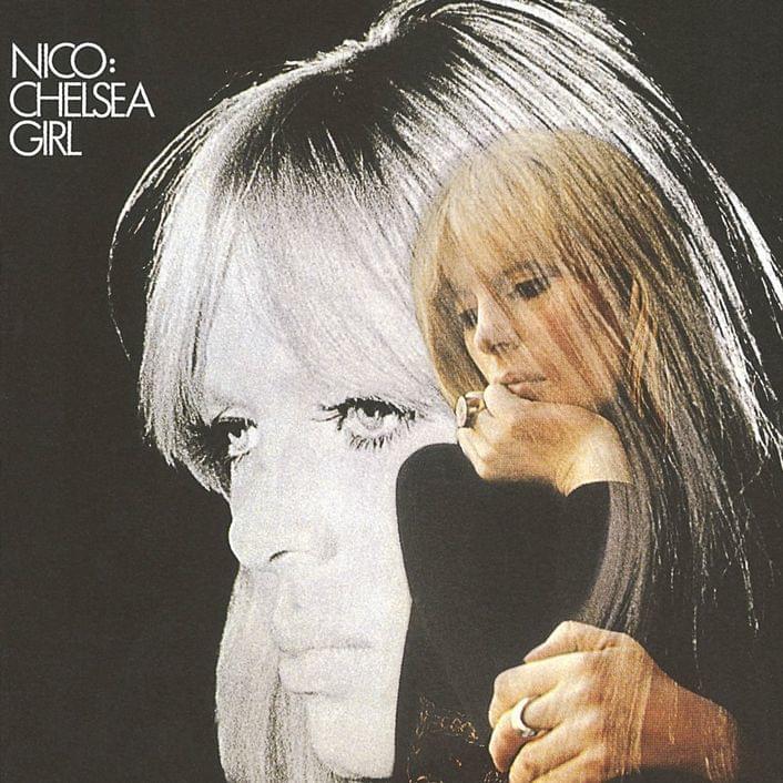 Nico album cover. She is shown from hips up in a black shirt, chin resting in one hand, the other resting on an unseen surface. In the background is an even larger portrait of her face looking out to the left